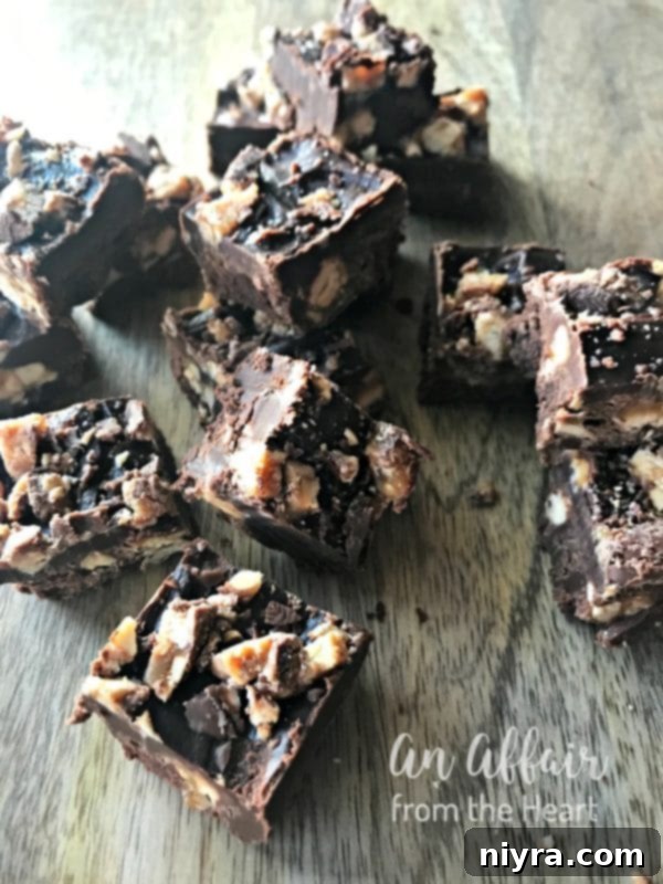 Candy Bar Fudge {Snickers Fudge} on a rustic wood table