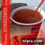 Icy Tempest Slush 2 hand holding a frozen hurricane slush with text of the same