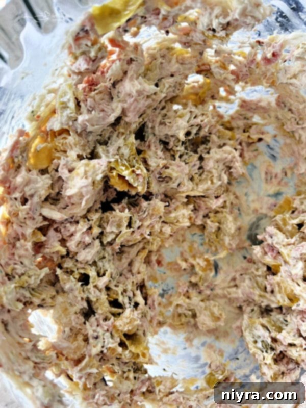 Mixing Brussels sprouts, ham, and cream cheese for the dip