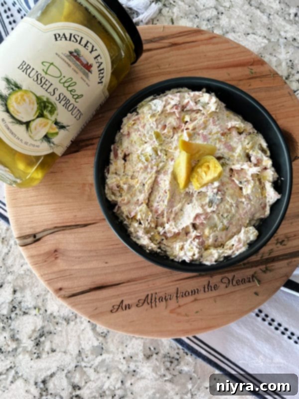 Dilled Brussels Sprouts Dip in a serving bowl with a spoon