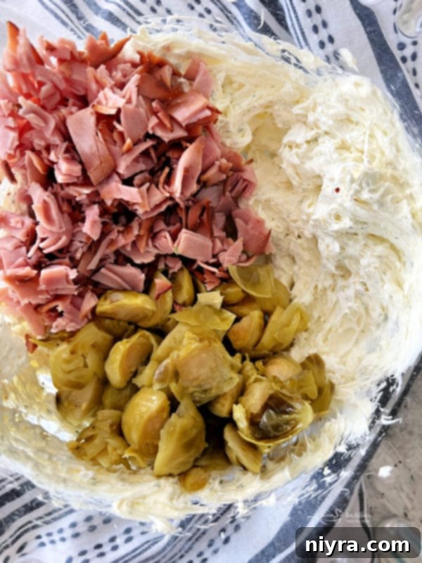 Whipping cream cheese and fresh dill in a mixing bowl