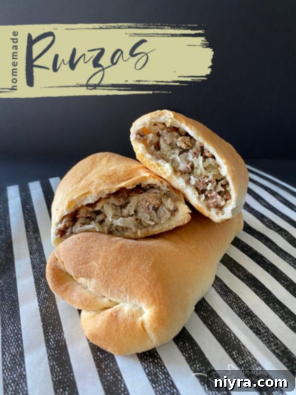 Homemade Runzas on a wooden cutting board, with a focus on their golden crust