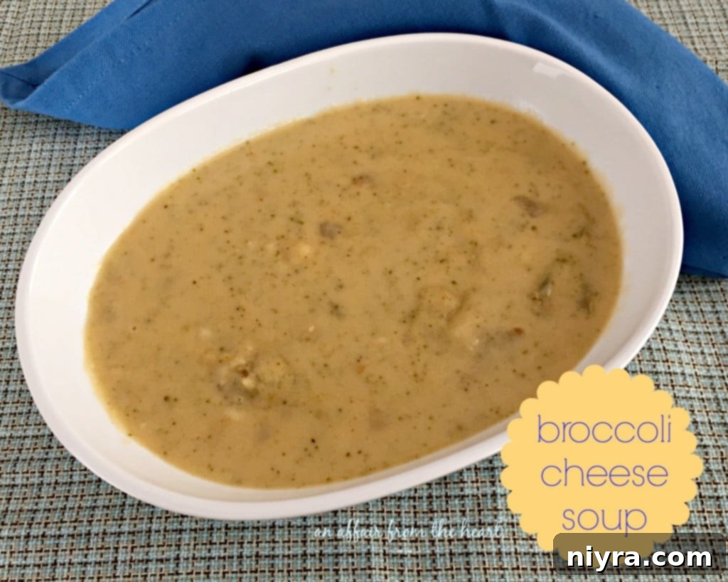 A close-up shot of a steaming bowl of broccoli cheese soup with croutons