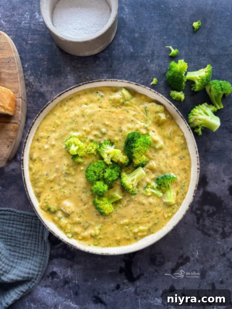 Close-up of rich broccoli cheese soup with a spoon