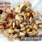 Overhead shot of Peanut Butter Puppy Chow spread out on a white cloth