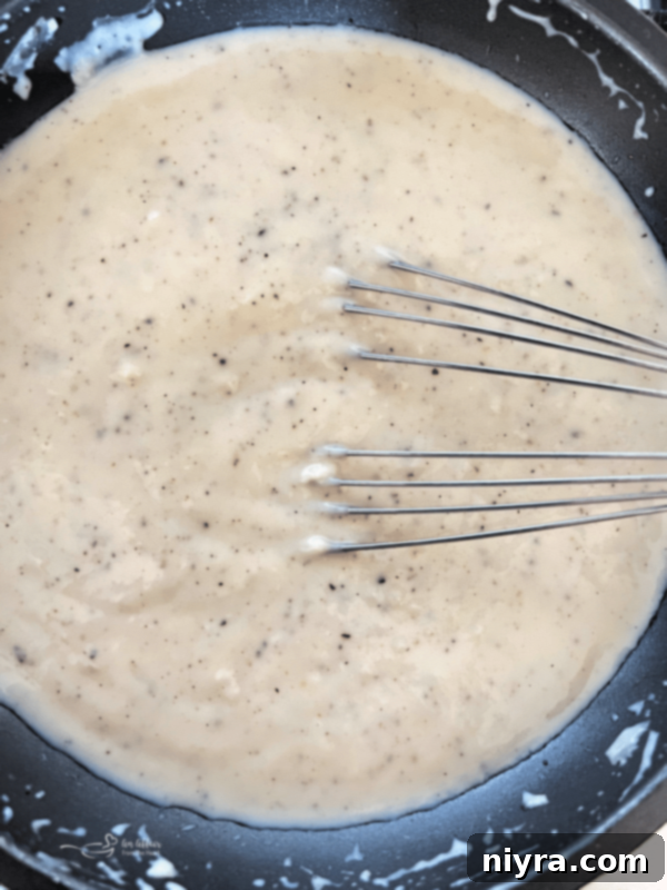 Classic Southern White Gravy 11 Finished white country gravy in a skillet