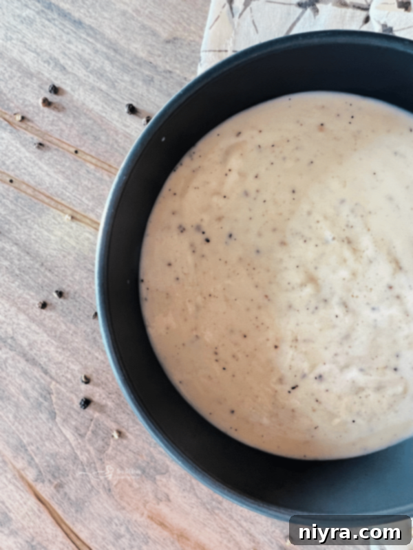 Classic Southern White Gravy 14 Close-up of white country gravy with a spoon