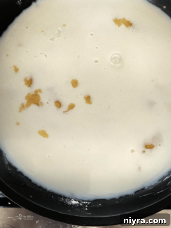 Classic Southern White Gravy 9 Slowly adding milk to the roux