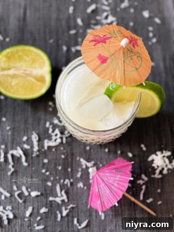 Creamy Brazilian Lemonade Cocktail garnished with lime and umbrella