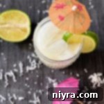 Overhead of Mini Vacation - aka Brazilian Lemonade Cocktails garnished with limes and cocktail umbrellas