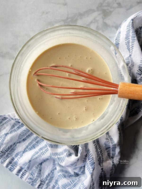 Wet ingredients for lemon glaze: heavy cream, egg, vanilla extract