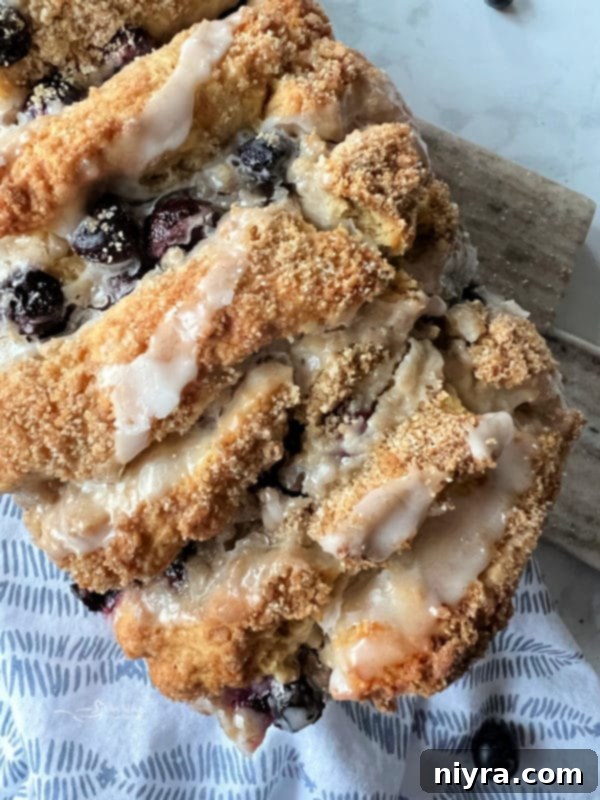 Blueberry Scone Bread covered in a glistening lemon glaze, ready to be served