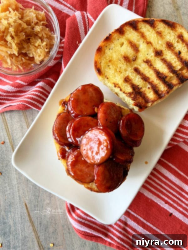 Scooping BBQ smoked sausage onto a toasted bun