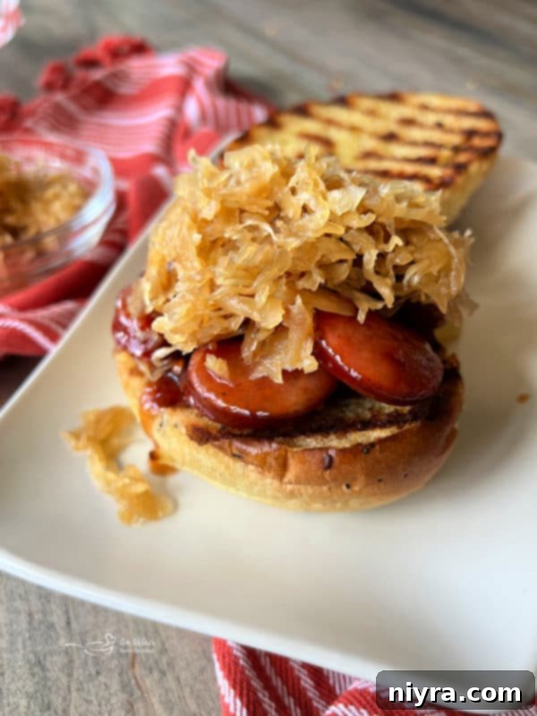 BBQ smoked sausage sandwich topped with Frank's Kraut