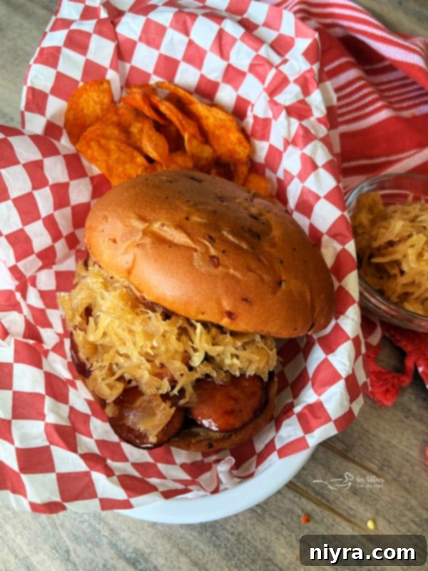 Smoked sausage slices coated in BBQ sauce in a cast-iron skillet