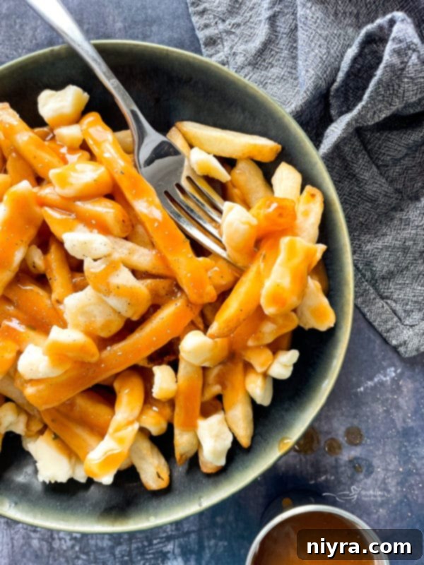 Canadian Poutine in a bowl with fork