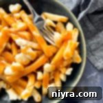 Canadian Poutine in a bowl with a fork