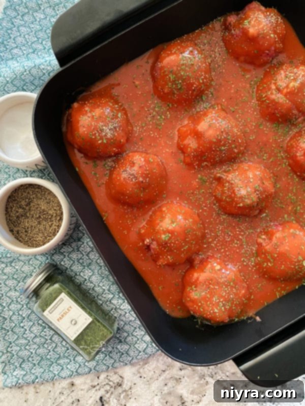 Sauce covering porcupine meatballs in a pan