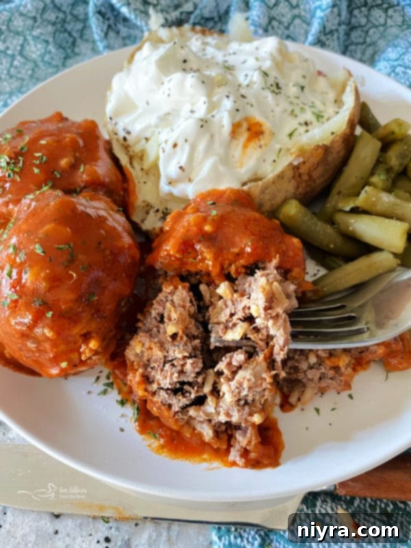 Porcupine meatball served with a baked potato and green beans