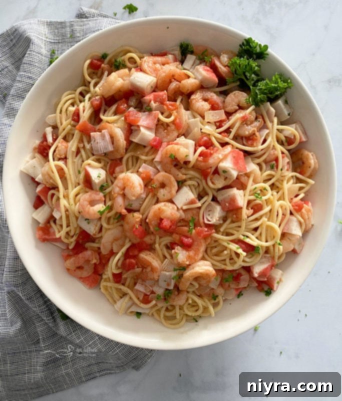 Close-up of a serving of Shrimp and Crab Pasta, highlighting the shrimp, crab, and tomato sauce.