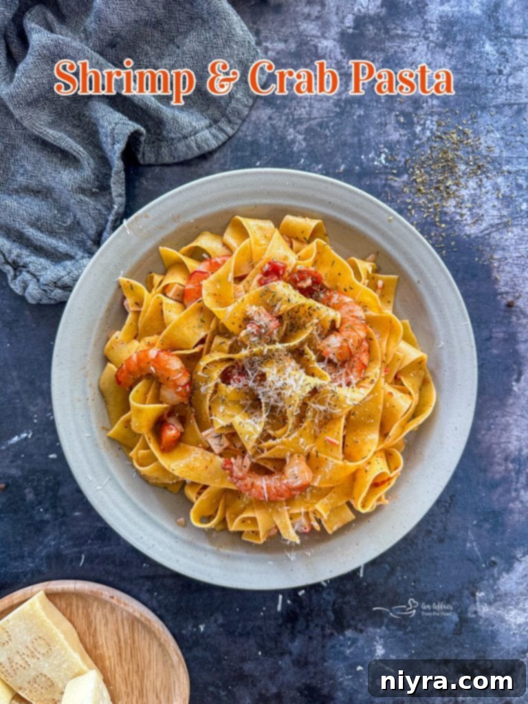 An appetizing close-up of a serving of Shrimp and Crab Pasta, with steam gently rising.