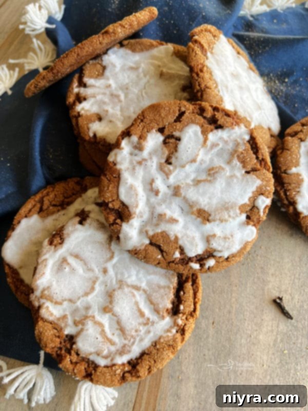 Iced Molasses Ginger Cookies with a blue linen background, a suggested related recipe.