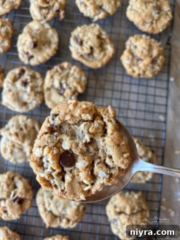 A second close-up image of stacked Cowboy Cookies, highlighting the golden-brown edges and abundance of mix-ins.