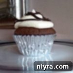 Side view of Double Chocolate Orange Cupcakes with Orange Butter Cream Frosting