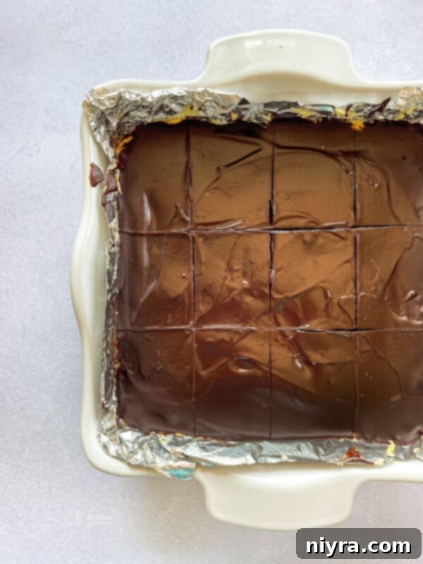 Spreading chocolate ganache over the Nanaimo Bars