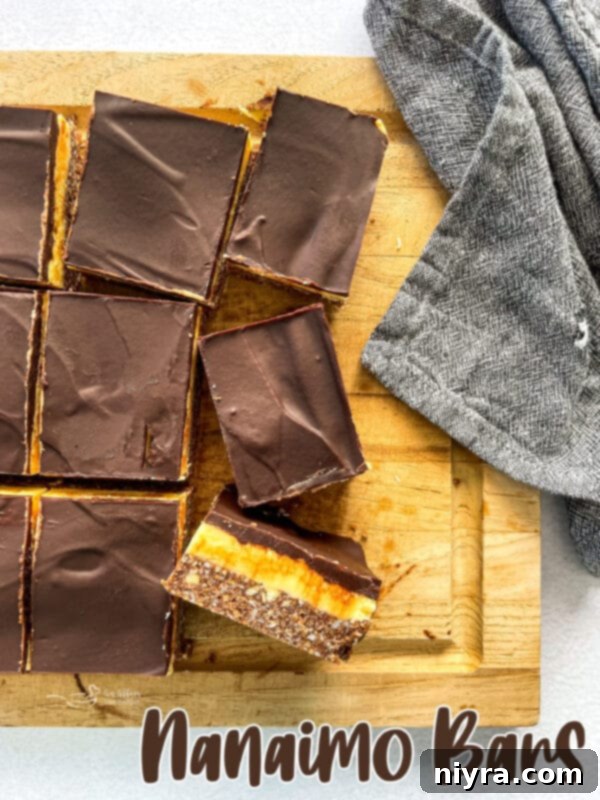 A beautifully presented tray of Nanaimo Bars, highlighting their layers and textures