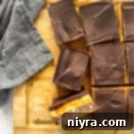 Nanaimo Bars sliced on a wooden platter