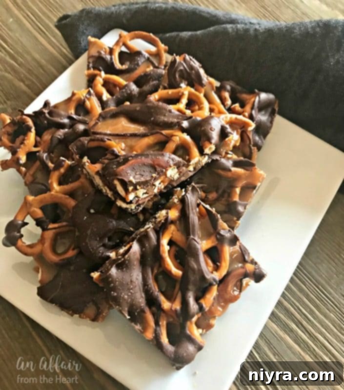 Salted Caramel Chocolate Pretzel Bars stacked on a white plate