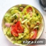 close up of Columbia 1905 Salad in a cream colored bowl.