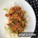Slow Cooker Chicken Teriyaki on rice on a white plate