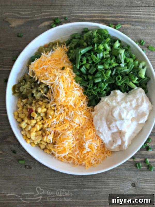 Champion's Irresistible Dip 6 Hands mixing the ingredients for Award-Winning Crack Dip in a large bowl with a wooden spoon.