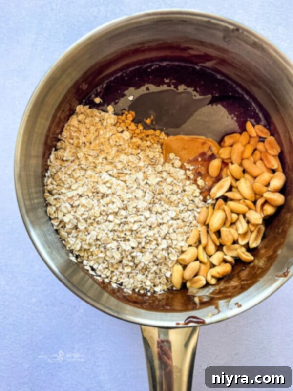 Sugar, cocoa, evaporated milk, and butter boiling in a saucepan, a key step for no-bake bars to set.