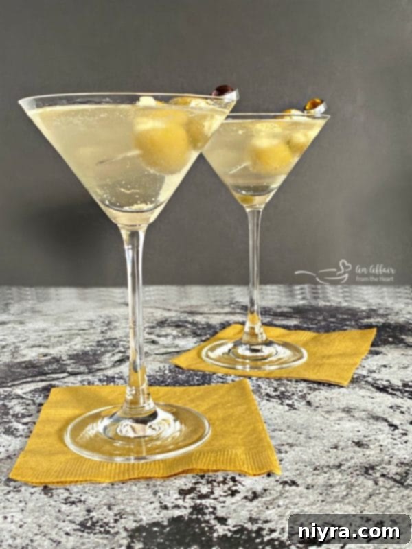 Two Dirty Bird Martinis, a classic cocktail with green olives