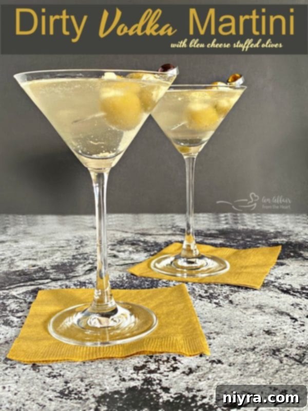 Two Dirty Vodka Martinis with Bleu Cheese Stuffed Olives, close-up shot