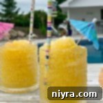 Subzero Vodka Bliss 10 Side view of Frozen Vodka Slush with an umbrella and straw in it