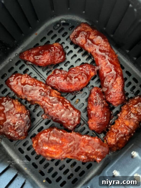 Crispy Air Fryer BBQ Tenders 2 Delicious Air Fryer BBQ Chicken Tenders on a plate