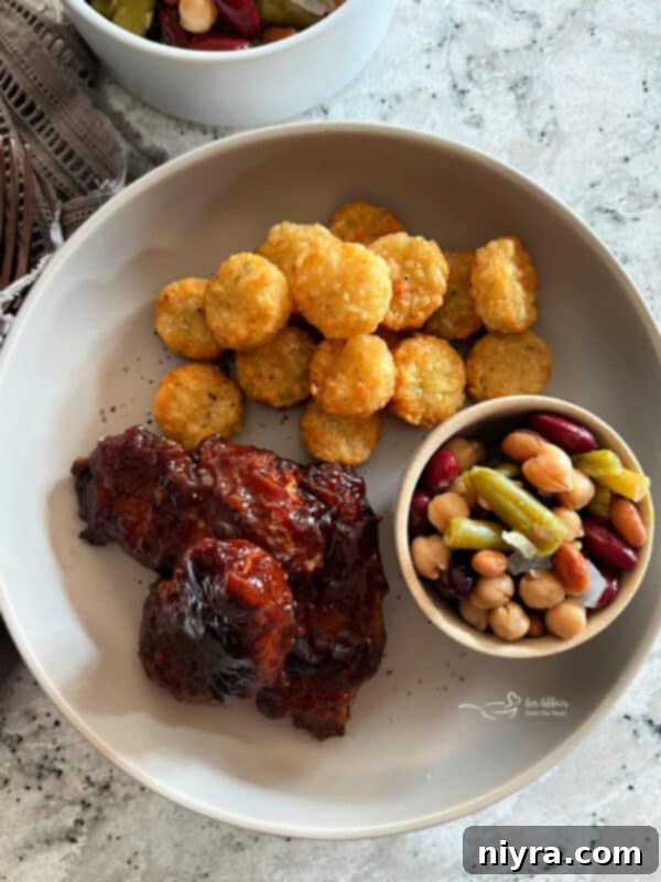 Crispy Air Fryer BBQ Tenders 19 Air Fryer BBQ Chicken Tenders served with tater tots and bean salad