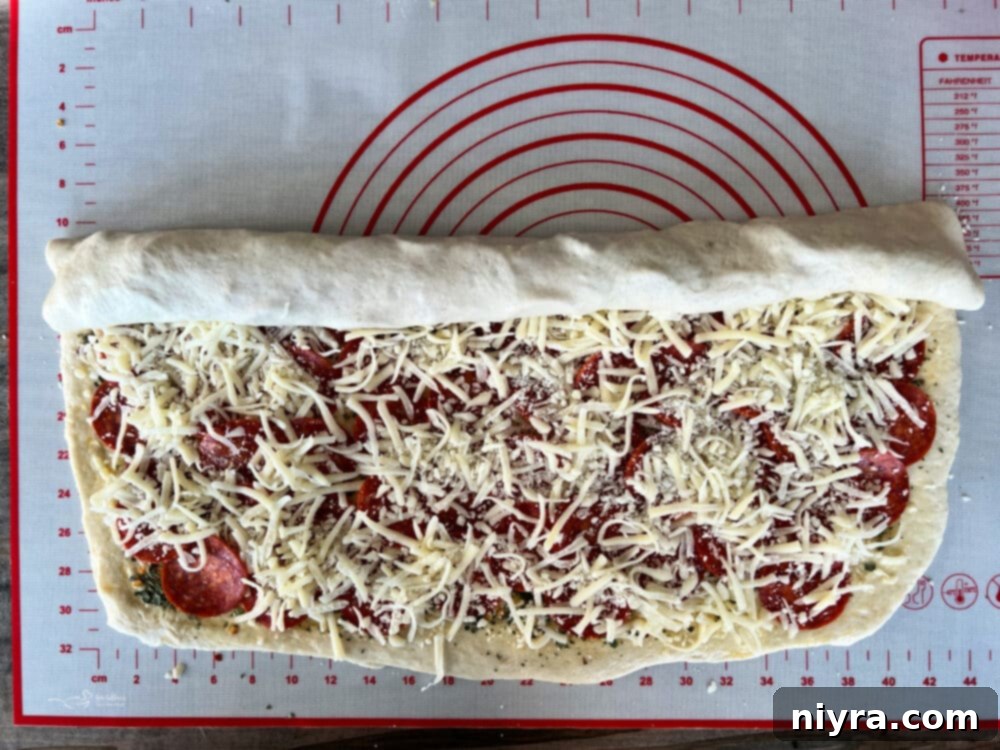 Dough layered with pepperoni and cheese