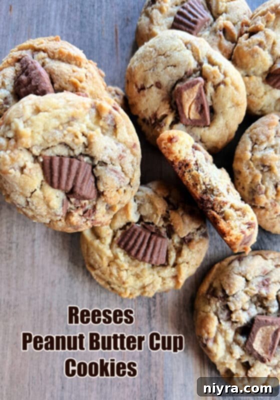 A large pile of Reese's Peanut Butter Cup Cookies with some unwrapped Reese's cups.