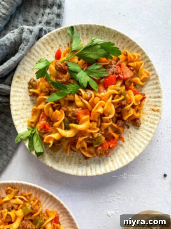 A vibrant bowl of Pizza Pasta, brimming with colorful ingredients and cheese.