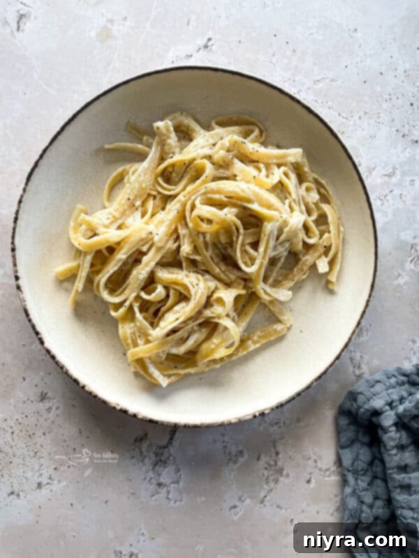 The Instant Pot filled with ingredients for Fettuccine Alfredo, ready for cooking.