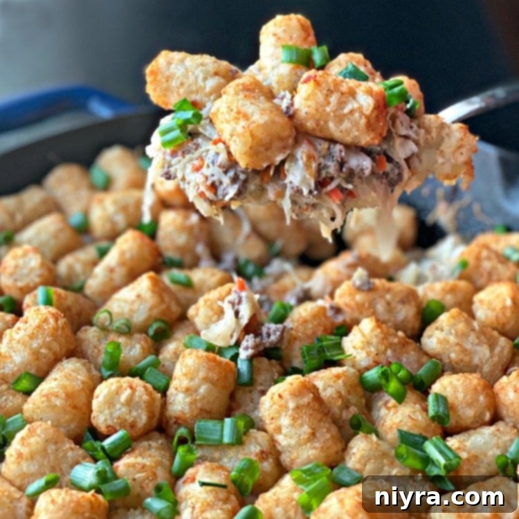Beef & Kraut Tater Tot Casserole spoonful being served