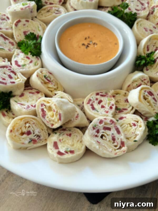Reuben Style Tortilla Roll-Ups arranged on a wooden board