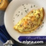 Overhead view of a perfectly cooked omelet on a white plate