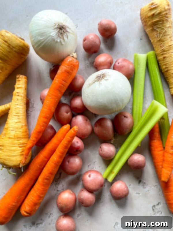 Various ingredients for pot roast laid out on a wooden cutting board, including fresh herbs, garlic, and tomato paste, ready for preparation.