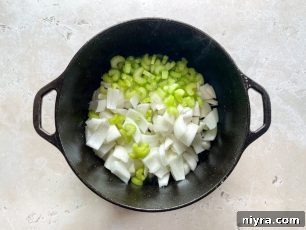 Chopped onions and celery sautéing in a Dutch oven after the roast has been removed, starting to soften and brown.